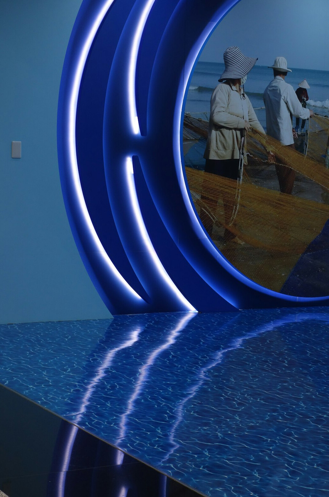 News anchor desk on a television set with illuminated backdrop